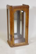 A bur walnut display cabinet with bevelled glass door and side panels, 35" x 17" x 13"