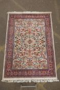 A Belgian cream ground wool Persian design carpet, decorated with an allover floral pattern and