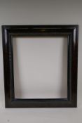 An early C20th Dutch style picture frame, with simulated tortoiseshell and ripple decoration, 18"