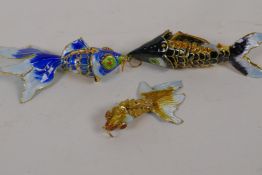 Three small enamelled articulated models of exotic fish, largest 3½" long