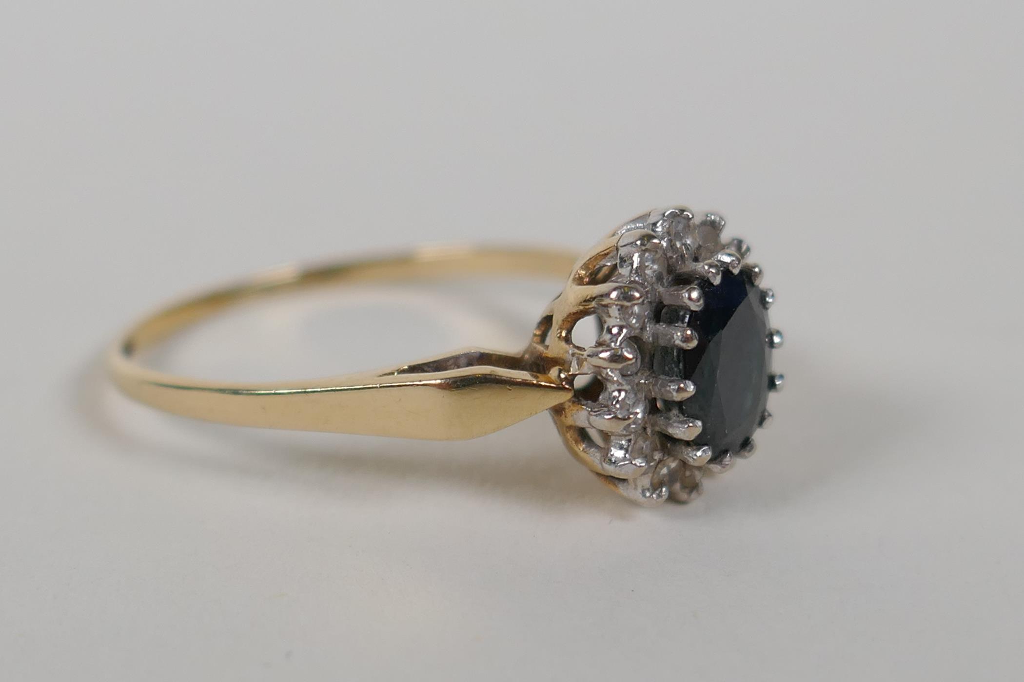 A 9ct yellow gold ring set with a blue stone encircled by diamonds, size Q/R - Image 2 of 3