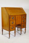 A Victorian walnut bureau with boxwood stringing, the fall front with a fitted interior, above six