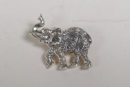 A sterling silver brooch in the form of an elephant, 1" wide
