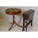 A small yew wood drum table with inset leather top, two true and four false drawers, raised on