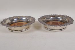 A pair of silver plate and turned wood wine coasters with cast fruit and vine decoration, 7½"