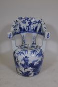 A Chinese blue and white porcelain garden stool decorated with travellers in a landscape, 26" high