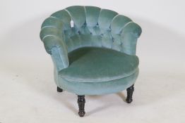 A small Victorian button back tub chair on turned supports