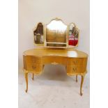 A vintage bleached wood kidney shaped kneehole dressing table with triptych mirror and five drawers,