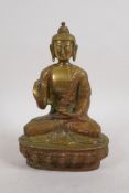 An Oriental gilt brass Buddha seated on a lotus throne, 8" high