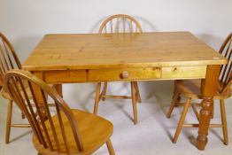 A pine kitchen table with single drawer and four hoop back beechwood chairs, 34" x 54"