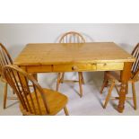 A pine kitchen table with single drawer and four hoop back beechwood chairs, 34" x 54"