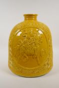 A Chinese yellow glazed porcelain water pot with raised decorative figural panels, impressed seal