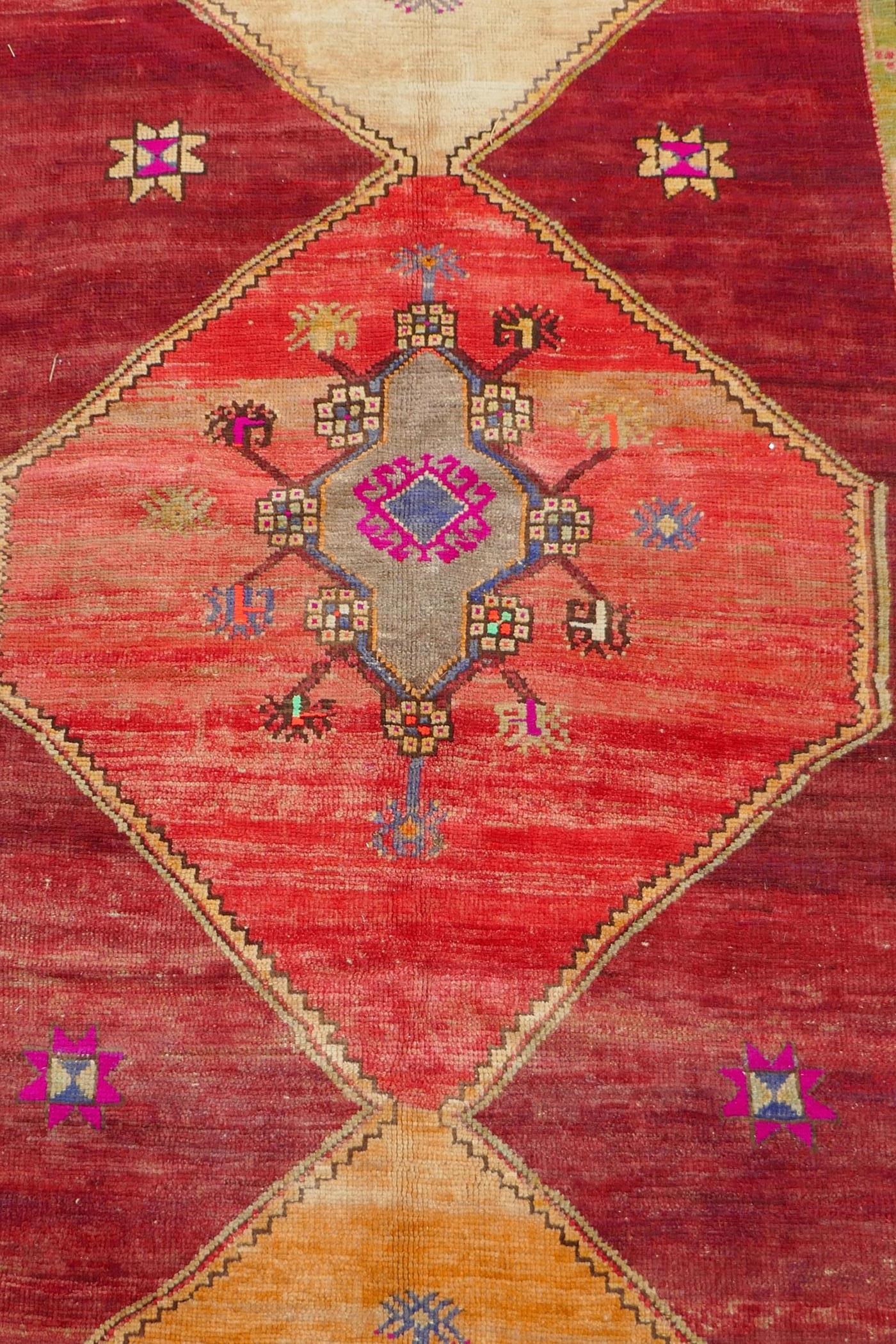 An Afghan rust ground full pile wool carpet with a tri-colour medallion design, 57" x 97" - Image 2 of 5