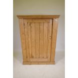 A pine single door cupboard, 43" x 21" x 58"