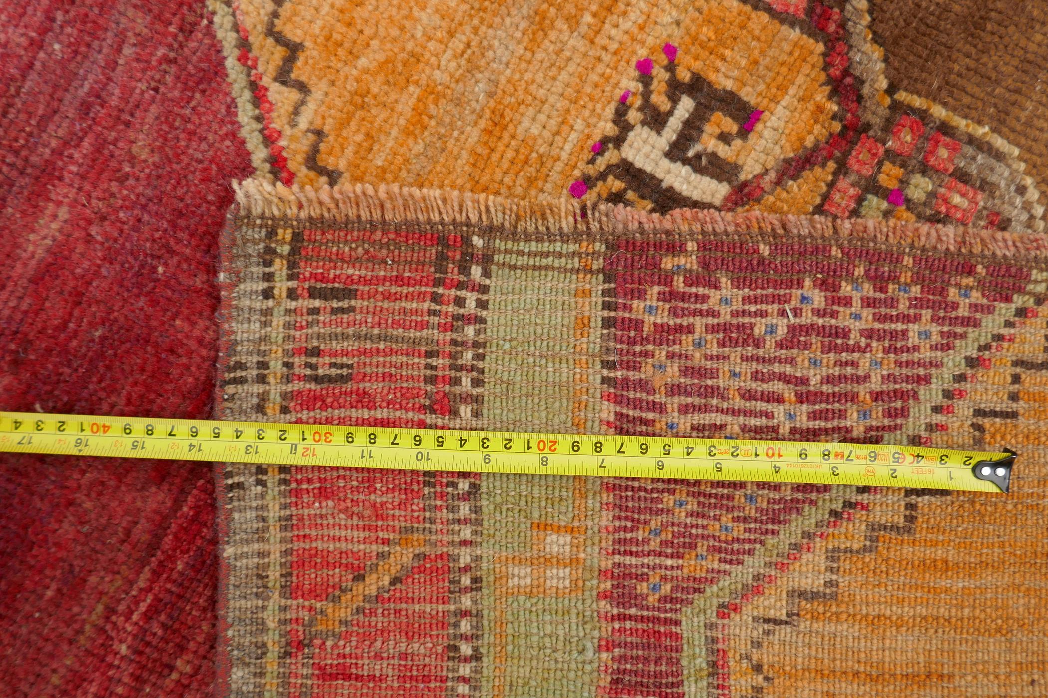 An Afghan rust ground full pile wool carpet with a tri-colour medallion design, 57" x 97" - Image 5 of 5