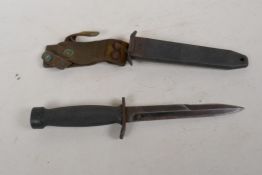 A commando dagger in metal and leather sheath, 12" long