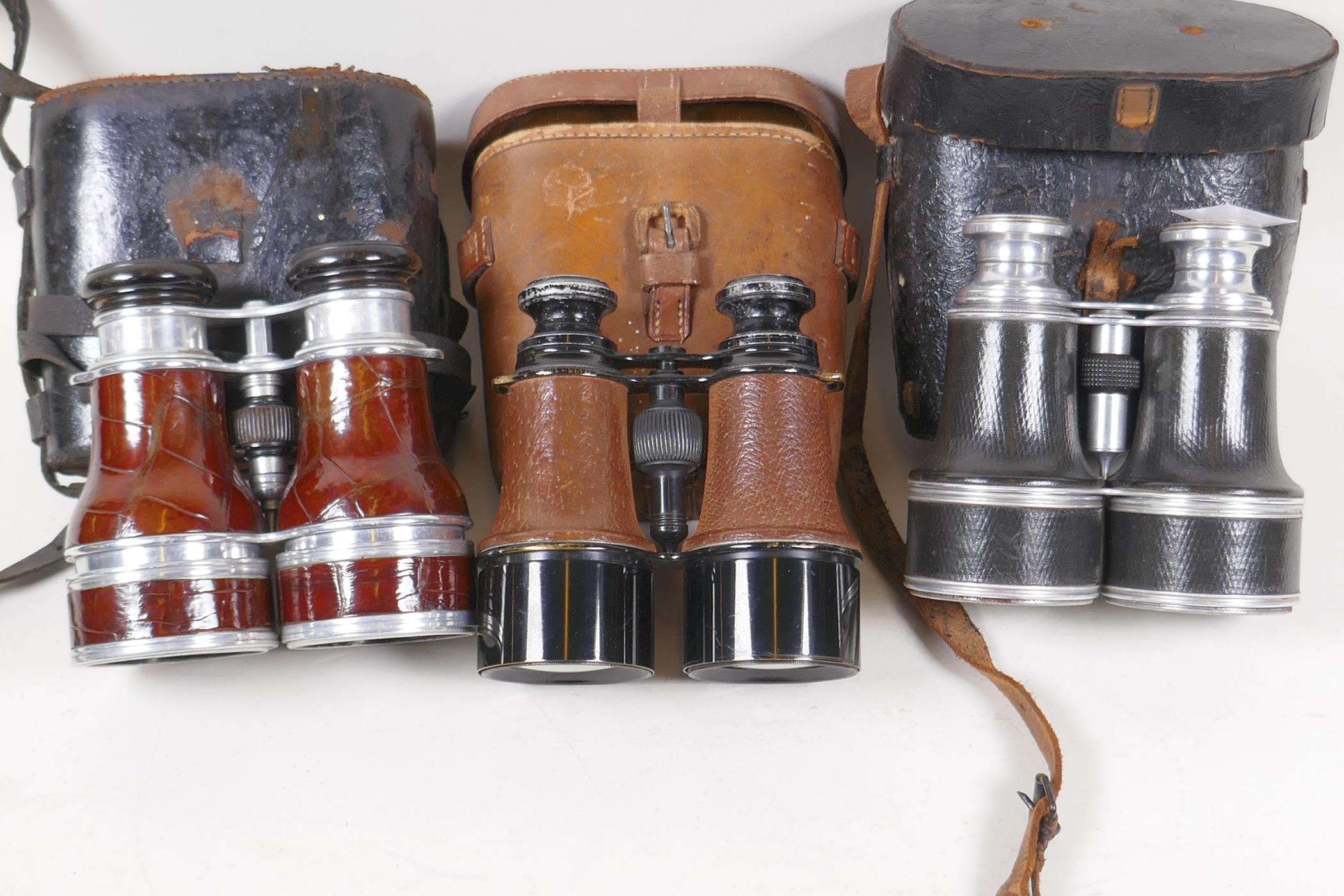 Three pairs of vintage binoculars in leather cases