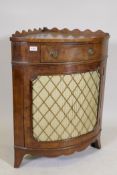 An early C20th yew wood corner cabinet with a shaped gallery and fringe, raised on swept feet, the