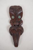 A Maori carved hardwood wall mask with abalone eyes, 9½"