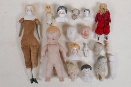 A quantity of vintage porcelain doll heads and other appendages