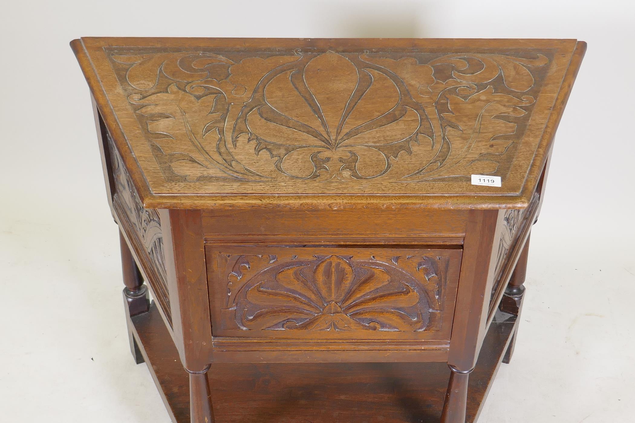 An early C20th walnut credence cabinet with carved panels and turned supports united by an - Image 2 of 3