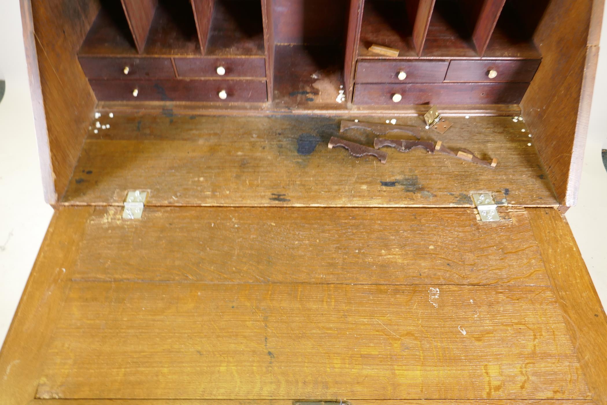 A Georgian oak fall front bureau, the interior fitted with drawers and pigeon holes over four long - Image 3 of 5