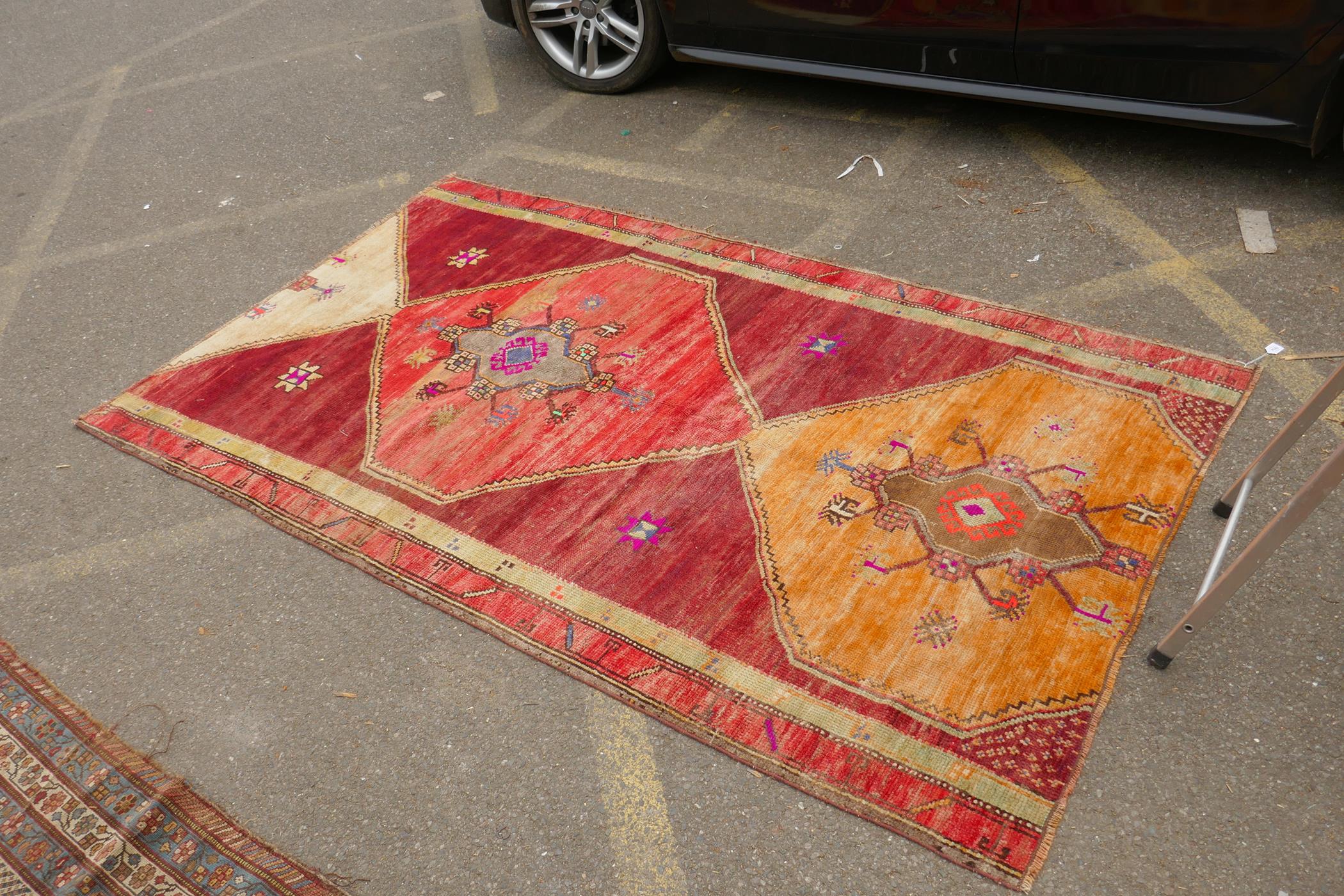 An Afghan rust ground full pile wool carpet with a tri-colour medallion design, 57" x 97" - Image 3 of 5