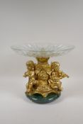 A marble and ormolu centrepiece with a glass bowl and winged putti decoration, 11" high x 12"