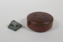 A Chinese copper trinket box with repousse dragon decoration to the cover, and a miniature bronze