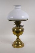 An antique British made brass oil lamp with a glass shade, 19" high