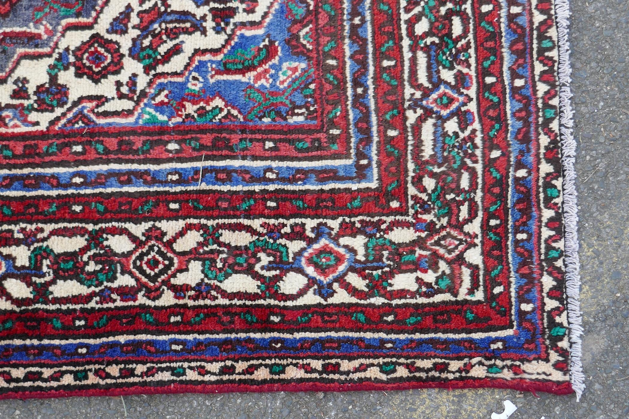 A red ground full pile Persian Sarouk carpet with traditional floral design, 83" x 122" - Image 3 of 4