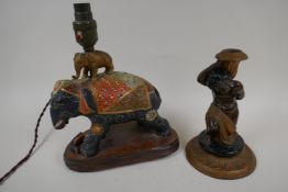 A painted metal figural candlestick, 8" high, and a ceramic lamp base made as an elaborately