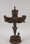A Sino Tibetan gilt bronze ornamental phurba/winged figure, 11" high