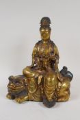 A Chinese filled bronze figure of Quan Yin seated on a kylin, impressed 6 character mark to base and