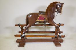 A child's rocking horse on trestle base, recently restored, early / mid C20th, 50" x 42"