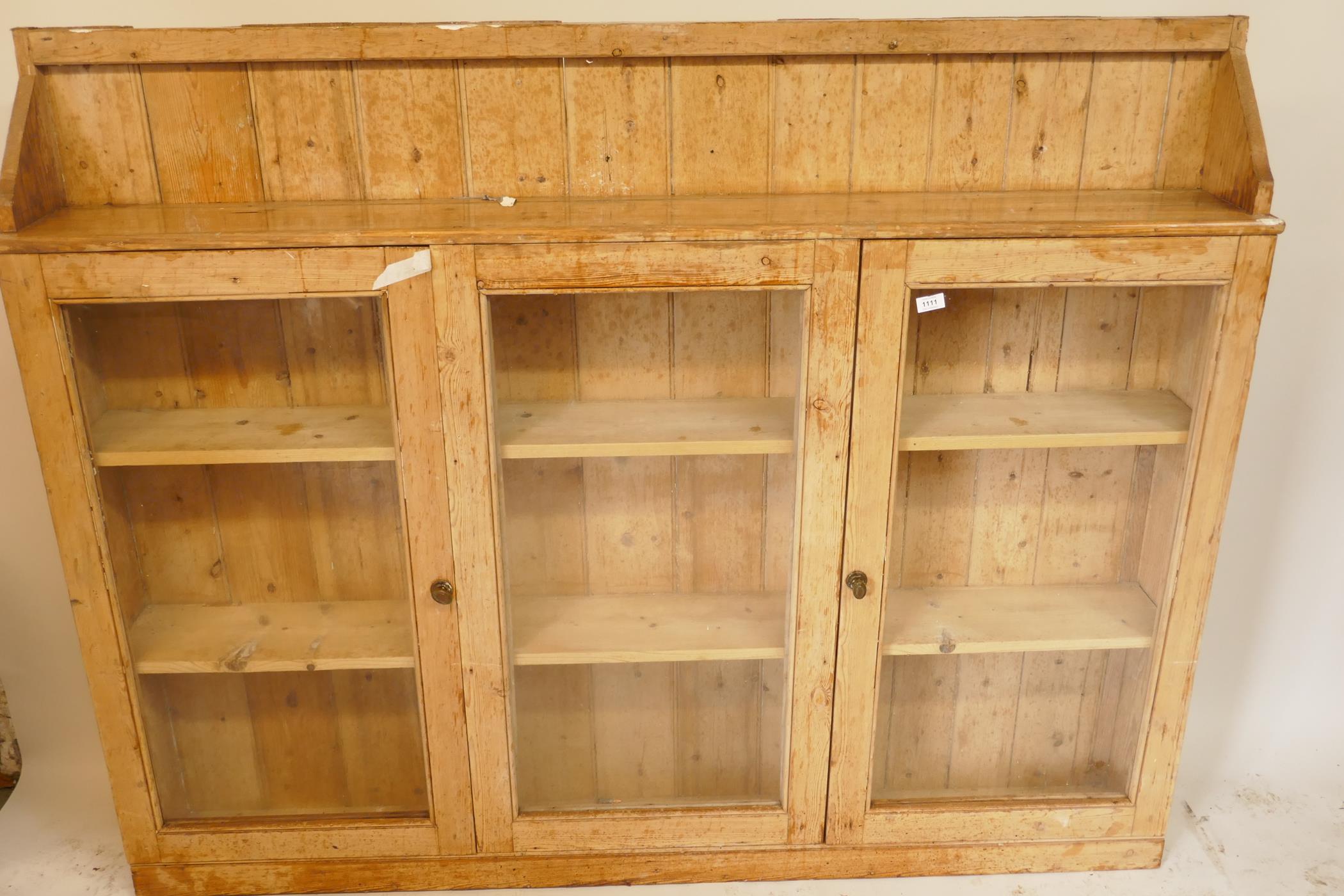 An antique stripped pine side cabinet, with three glazed doors, 69" x 9" x 54" - Image 2 of 2