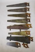 Eight vintage carpenters handsaws with wood handles, largest 30", two with period leather cases