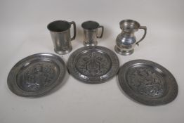 Three C19th pewter plaques embossed with coats of arms, 9" diameter, and three pewter tankards