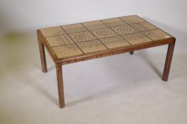 A mid century teak coffee table with inset tile top, 41" x 25" x 17"