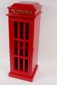 A cabinet in the form of a red telephone box, with lattice door, 20" x 7" x 7"