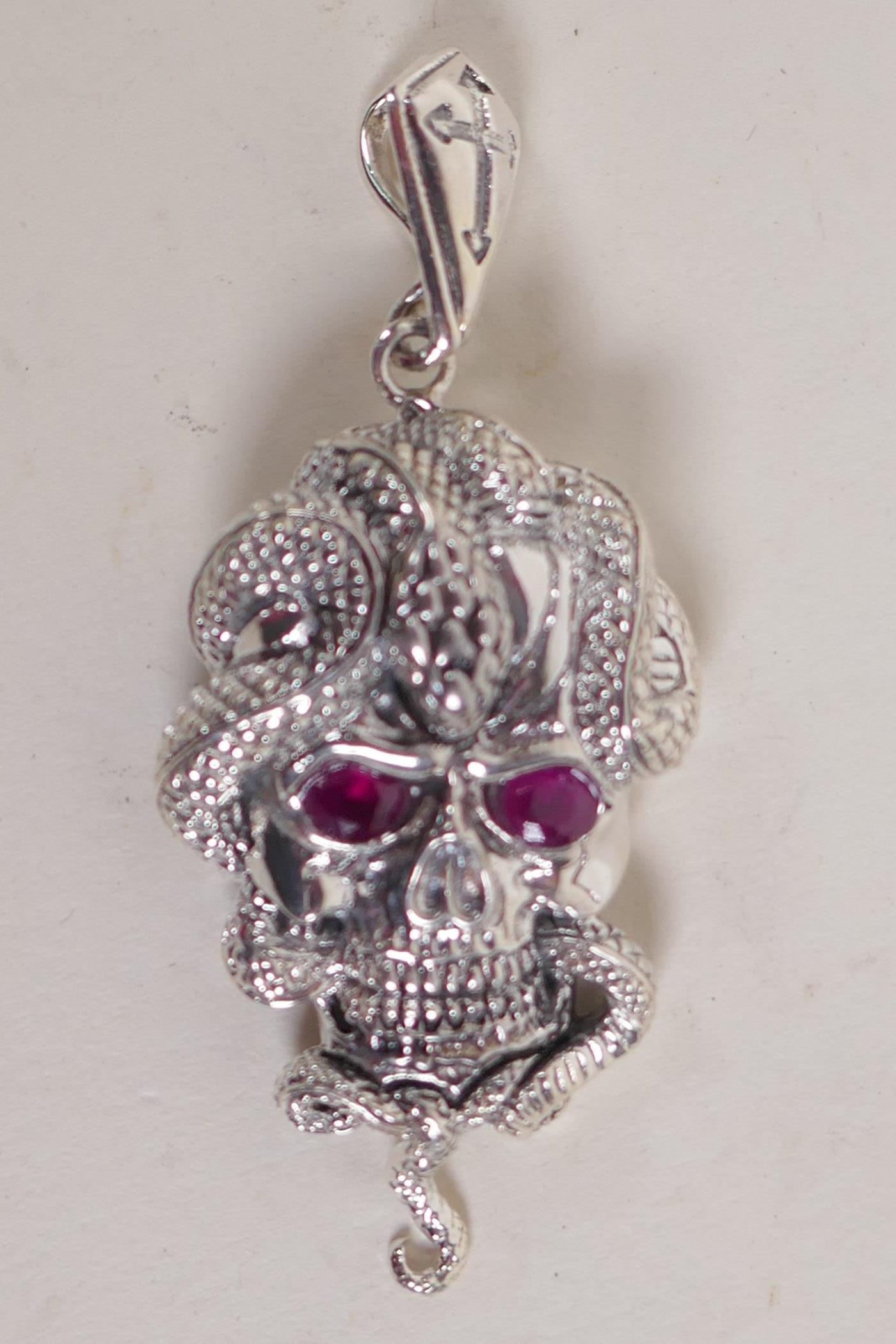 A silver 'snake and skull' pendant with stone set eyes, 2" long - Image 2 of 2