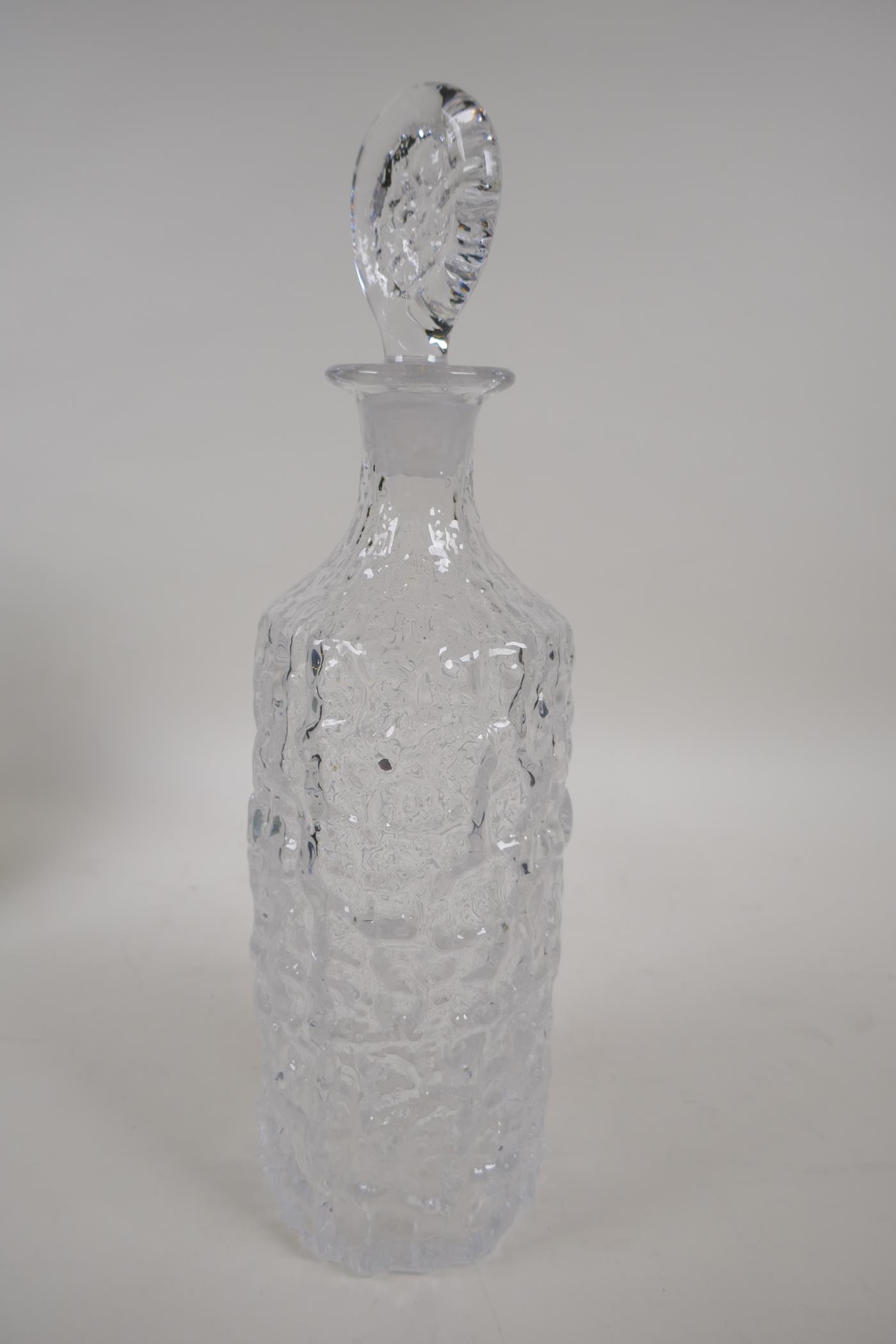 A Whitefriars bark finish clear glass decanter and stopper, 13" high