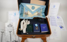A suitcase of masonic regalia and memorabilia, including a 9ct gold tie pin, 1.2g