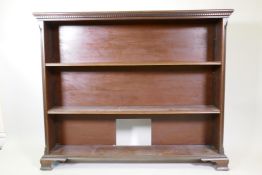 A mahogany open bookcase with dentil cornice, and two adjustable shelves, raised on ogee supports,