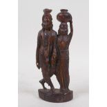 An Indian carved hardwood figure group of a man and woman in traditional clothing, 16cm high