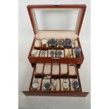 A two tier watch display box with a selection of wrist watches