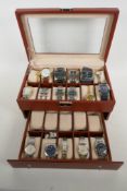 A two tier watch display box with a selection of wrist watches