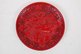 A Chinese cinnabar lacquer style dish with riverside landscape decoration, 15cm diameter