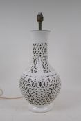 A vintage Chinese blanc de chine porcelain lamp with a pierced body, 37cm high