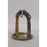 A brass stirrup with inset cloisonne decoration, 15cm high